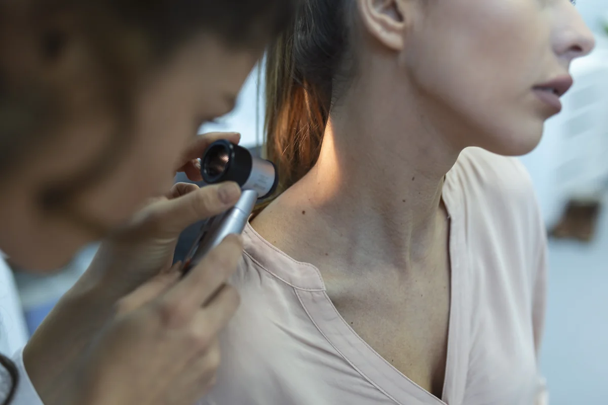Figure 1: Dermatologists use handheld polarized dermatoscopy to inspect pigment network patterns and symmetry.